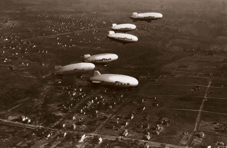 Six Goodyear blimps fly in formation in November 1930. The large