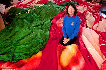 Family firm: Hannah Cameron, director at Cameron Balloons, with the fabric the company use. Her father Donald, a Scottish aeronautical engineer, created the company