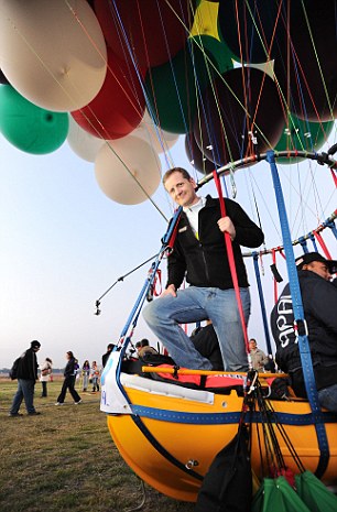 Jonathan Trappe poses in his cluster balloon craft before he took it out for a test run in Mexico Photo:   DailyMail.co.uk