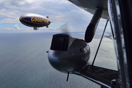 Looking out the windows of The Spirit of Innovation, The Spirit of Goodyear flies over Pompano Beach.  Photo: Mike Stocker / Sun Sentinel
