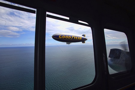 Looking out the windows of The Spirit of Innovation, The Spirit of Goodyear flies over Pompano Beach.  Photo: Mike Stocker / Sun Sentinel