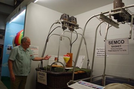 Dennis Nicholson, assistant curator at the National Balloon Museum explains one of the many exhibits showing different types of gondolas used in ballooning. Photo: Terry Turner 