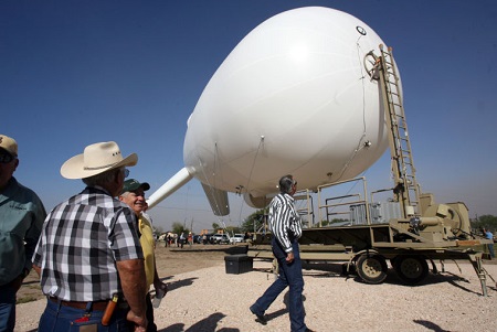 On Tuesday in Penitas, local land owners look over an aerostat that will aid in surveillance and be launched by the U S Border Patrol Rio Grande Valley Sector. Photo: Joel Martinez/The Monitor 