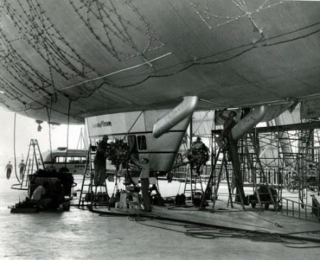 Goodyear blimp Mayflower is overhauled in 1949 at the Wingfoot Lake hangar in Suffield Township. The incandescent light framework attached to the envelope allowed the airship to spell out any letter or numeral at night on its giant advertising sign. Credit: Akron Beacon Journal