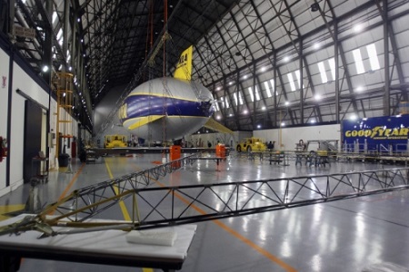 A part of the frame for the the second Zeppelin airship is laid out as Wingfoot One rests in the hangar at the Goodyear Airship base in Suffield Township on Friday. Goodyear has started building the second of three semirigid airships.  Photo: Mike Cardew - Akron Beacon Journal 