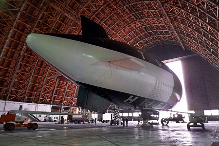 The Skyship 600B is seen inside Hangar 2 at the NASA Ames Research Center in Moffett Field, on Wednesday, Dec. 8, 1999. Leased by fashion designer Tommy Hilfiger, the $8 million airship, stretching two-thirds the length of a football field and as tall as a 747 jumbo jet, is the largest certified airship in operation today, and the first to visit historic Moffett Field for an extended period since 1947. Officials at the field say the Skyship is staying at the facility for routine maintenance, which includes getting a bath.  Photo: Ben Margot/AP Photo