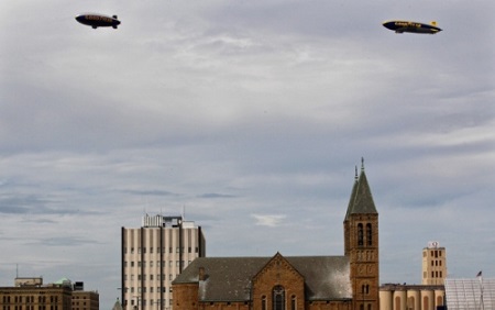 Two Goodyear airships, Wingfoot One (right) and Spirit of Innovation, conduct a tandem flight over the downtown Akron area on Wednesday.  Photo: Ed Suba Jr./Akron Beacon Journal