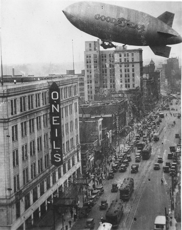The Pilgrim approaches the O’Neill’s Department Store building in downtown Akron as part of a promotional flight.
