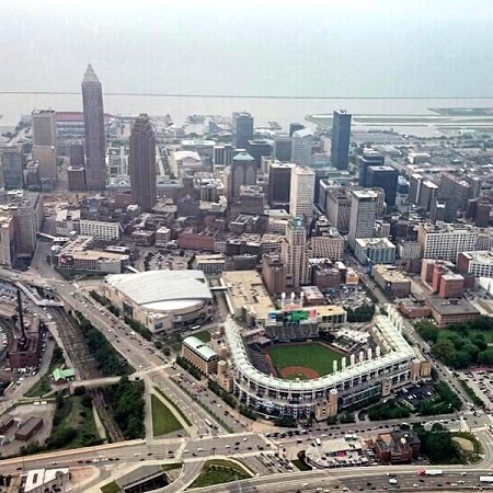 Progressive Field (baseball), the Quicken Loans Arena (basketball), downtown Cleveland Ohio and Lake Erie in the distance. Photo courtesy of DirecTV/Van Wagner Aerial Media on Twitter.