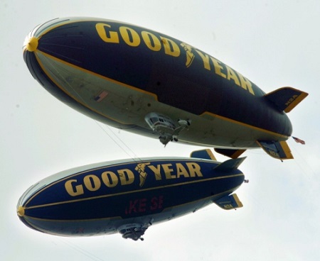 In this June 2006 file photo, The Goodyear Spirit of Innovation (top blimp) and Spirit of Goodyear blimps fly together over downtown Akron. Hoto: Akron Beacon Journal file photo. 