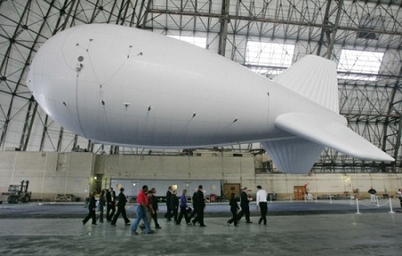 In this August 2010 file photo, politicians, Lockheed Martin officials and employees walk past one of the 17 additional aerostat-based Persistent Threat Detection Systems (PTDS) made ahead of schedule for the U.S. Army in Afghanistan before a celebration of their completion at the Akron Airdock in Akron. Three of the PTDS's were on display for the event. Photo: Karen Schiely/Akron Beacon Journal 