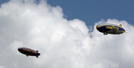 Goodyear Blimp Spirit of Innovation (left) and Goodyear Zeppelin Wingfoot One fly over Stan Hywet Hall for Community Day during its 100th anniversary celebration on Sunday in Akron. Photo: Mike Cardew/Akron Beacon Journal