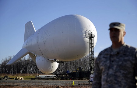 U.S. Air Force Col. William Pitts stands in front of an unmanned aerostat that is part of a new U.S. military cruise-missile defense system during a media preview in Middle River, Md., in December 2014. Photo credit: Patrick Semansky/AP 