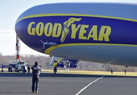 A technician takes a picture on his cell phone of the second new technology Goodyear Airship. Photo: David Dermer - Akron Beacon Journal.