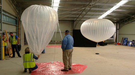 Technicians with NASA’s Columbia Scientific Balloon Facility inflate a zero-pressure balloon model as part of a display for the Warbirds Over Wanaka Airshow March 25-27 in New Zealand. A super pressure balloon model is seen in the background. Image courtesy of NASA